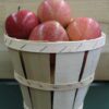 Fresh red apples in wooden bushel