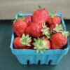 Fresh ripe strawberries in blue carton