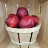 Rustic basket of glossy red apples