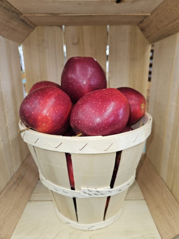 Rustic basket of glossy red apples