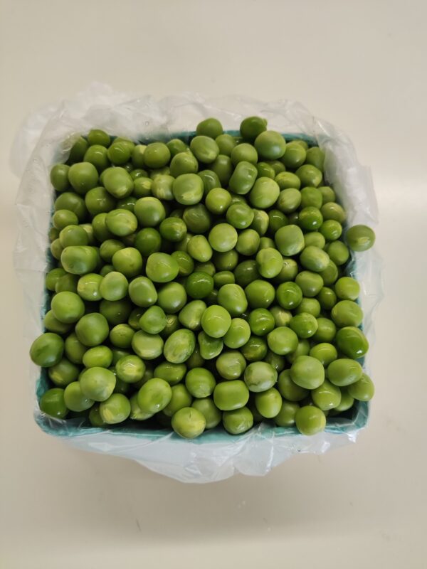 Container of vibrant fresh green peas