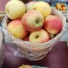 Basket of rosy yellow apples at market