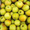 Plastic-lined crate of green apples