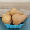 Russet pears in turquoise produce carton