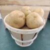 Small wooden basket of fresh potatoes