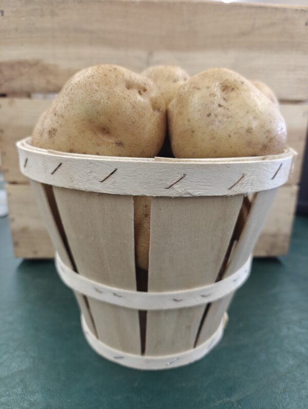 Small wooden basket filled with potatoes