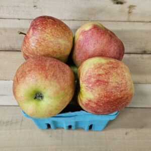 Basket of red apples on wooden surface. Basket of red apples on wooden surface.