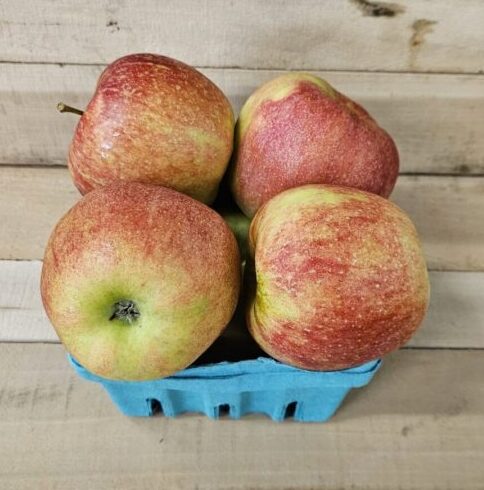 Basket of red apples on wooden surface. Basket of red apples on wooden surface.