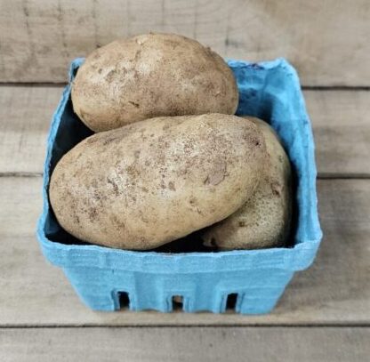 Basket containing several brown potatoes.